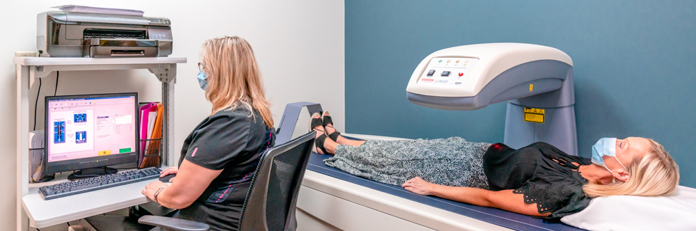 Female patient getting medically imaged while doctor looks over the results