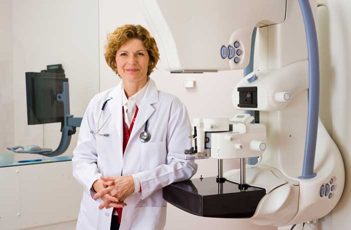 Smiling doctor in mammography studio