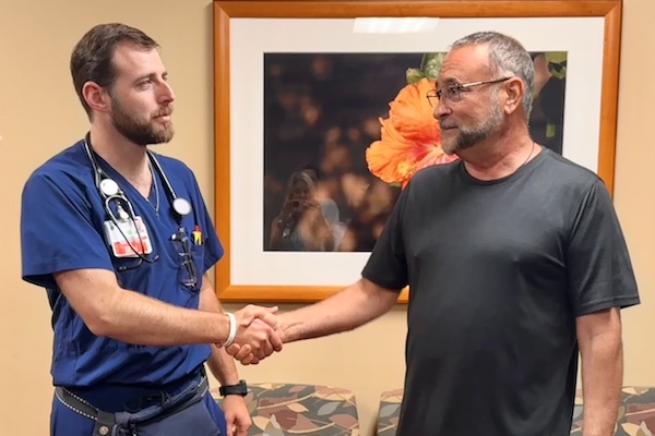 Former ICU patient shakes hands with Lakewood Ranch Medical ICU nurse, Ben Allen. 