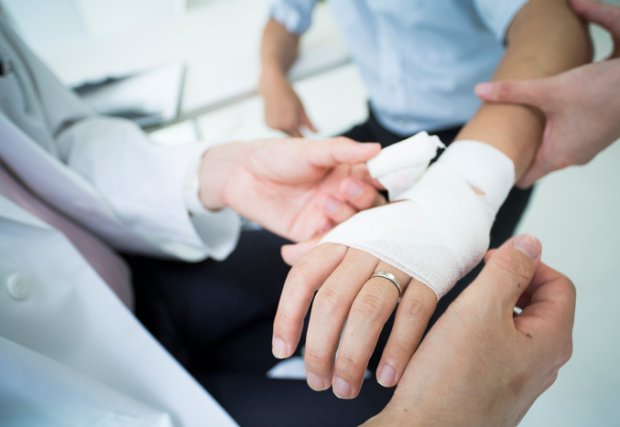 Patient hand getting bandaged