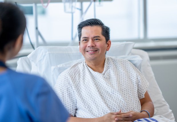 A male patient talking to a female nurse