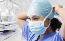 Medical professional putting on mask