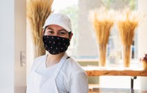 Bakery owner smiling while wearing a mask