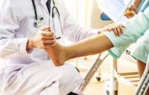 Doctor assessing a patient recovering from a leg injury